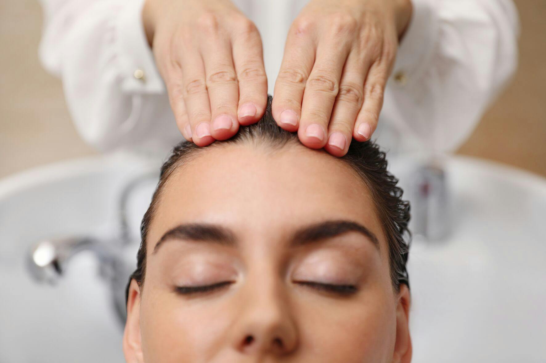 Photo of hairstylist applying hair mask