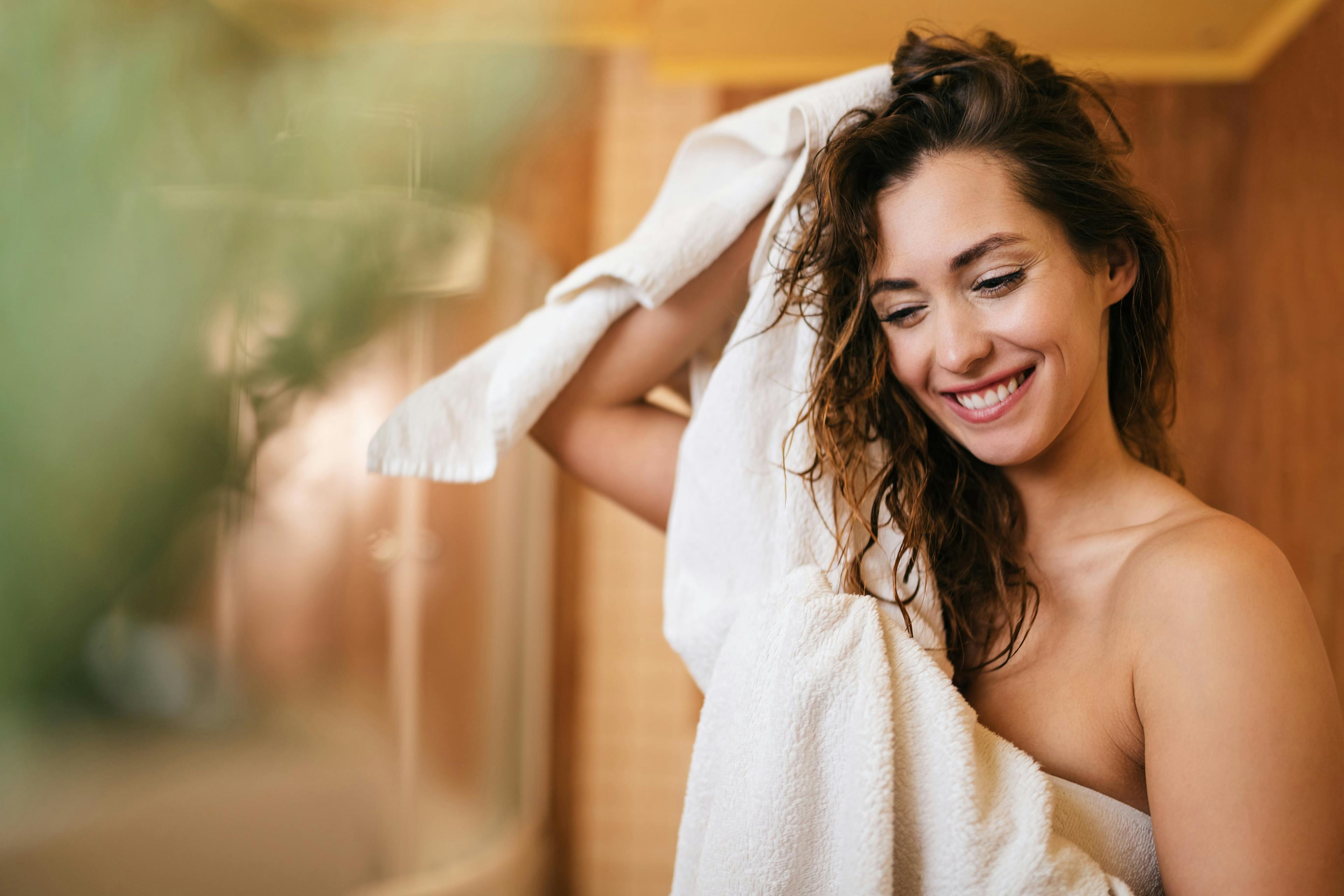 Image of woman drying her hair after washing